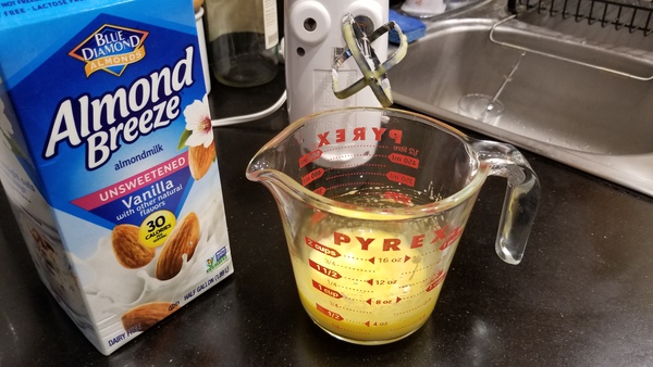 Beaten egg yolks with almond milk and electric mixer