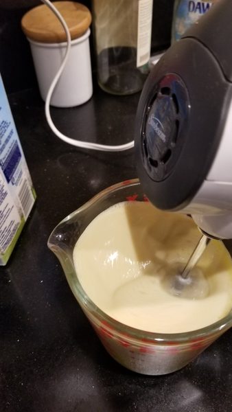 Beating egg yolks and milk with electric mixer