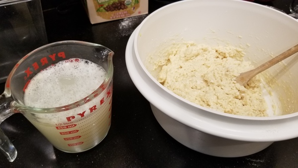 Dough-like stuff in bowl. Water in measuring cup.