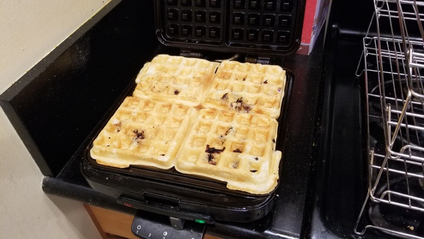 Cooked waffles on iron